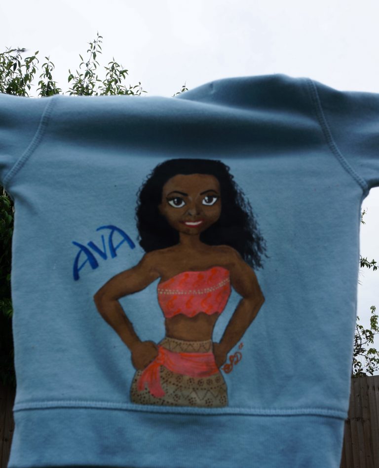hoodie painted with an adaptation of a picture of Moana changed to look like a different female. The name "Ava" is painted alongside.