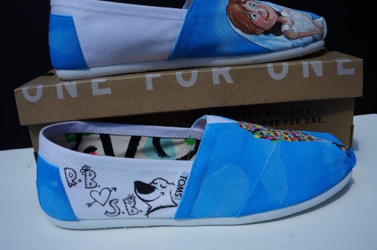 side view of some white toms and a cartoon sketch of Dug from the film Up and the initials of two people plaus a heart