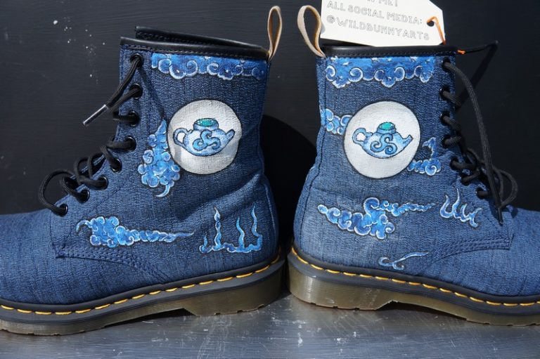 a pair of navy blue dr Martens with a chinese treapot design and chinese clouds